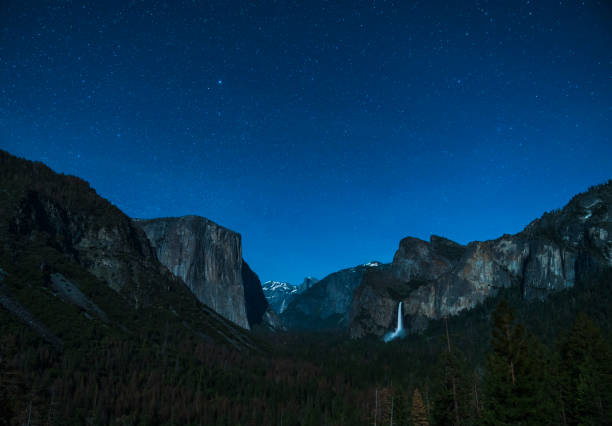 istock yosemite at night with star night sky background. 1168740657