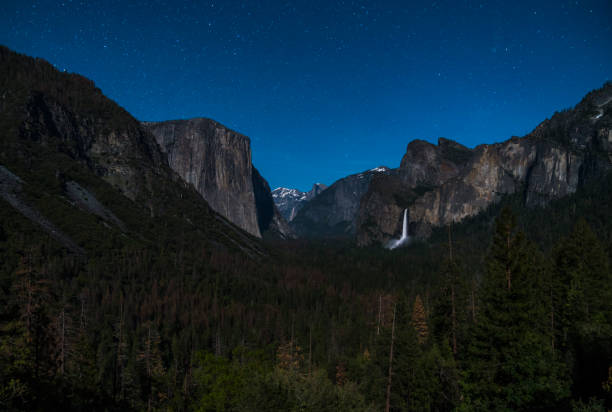 istock yosemite at night with star night sky background. 1168740661
