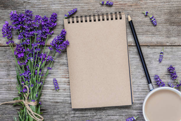 istock Creative layout made with lavender flowers, blank notepad and coffee cup on rustic wooden background. Flat lay 1168742966