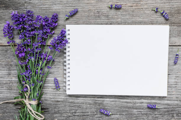 istock mock up blank paper card with lavender flowers on rustic wooden table. flat lay. wedding background 1168742984