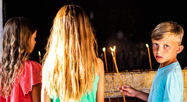 istock Kids burning a candles while praying 1168743212