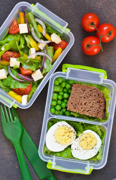 istock Lunch box with tomatoes, lettuce and sandwich. Top view. 1168743217