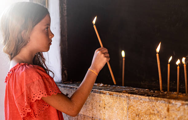 istock Side view beauty girl holding burning candle 1168743297