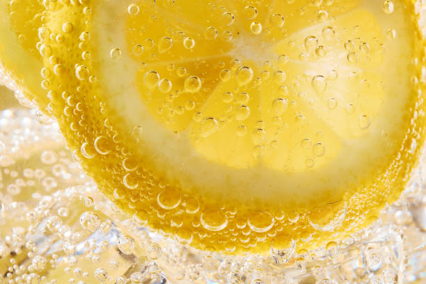 istock Close up of water with lemon slices and bubbles 1168744376