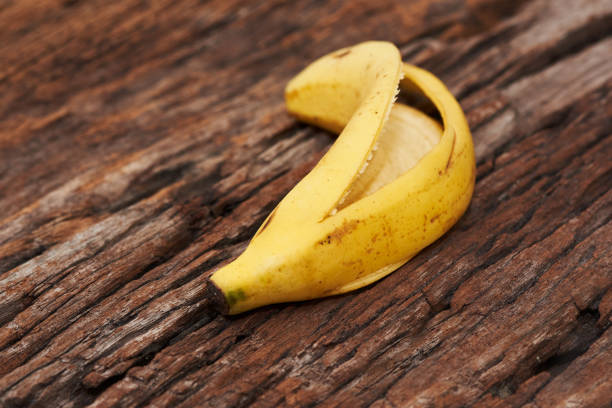istock Peeled banana on wooden background 1168744670