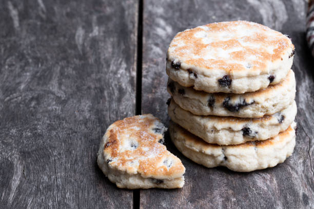 Stack of iced Welsh cakes on rustic wooden table Stack  of iced Welsh cakes on rustic wooden table welsh culture stock pictures, royalty-free photos & images