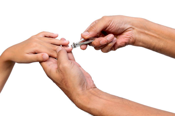 istock father's hand is using stainless steel nail clippers to cut the son's fingernail 1168746821
