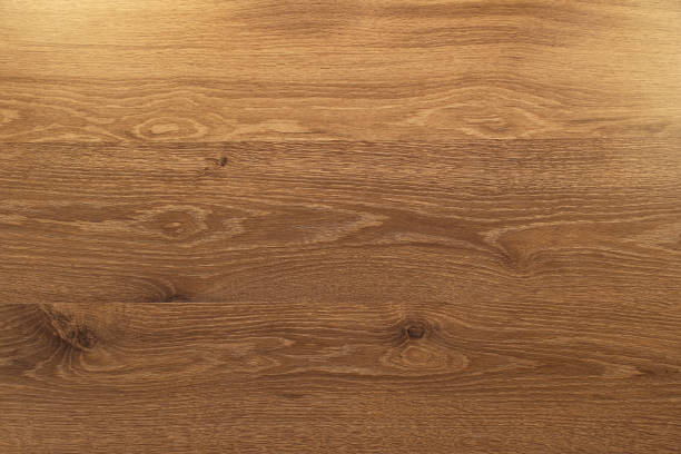 istock brown wooden plank desk table background texture with light top view 1168748113
