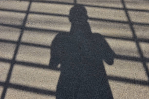 istock The shadow of human apper on the street. 1168748257