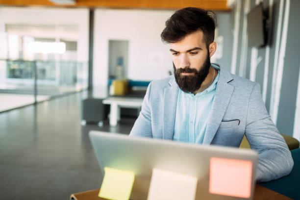 istock Young employee looking at computer monitor during working day 1168748386