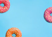 donuts of different colors on a blue background