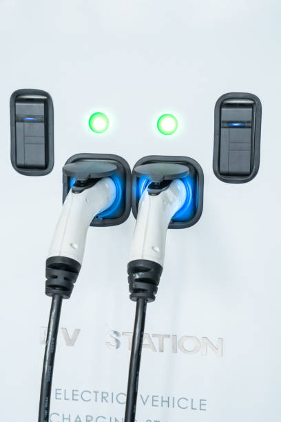 istock Car power charger with the EV car in background 1168749925
