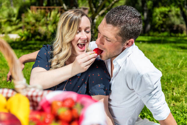 istock Pregnant woman feeding husband 1168749946