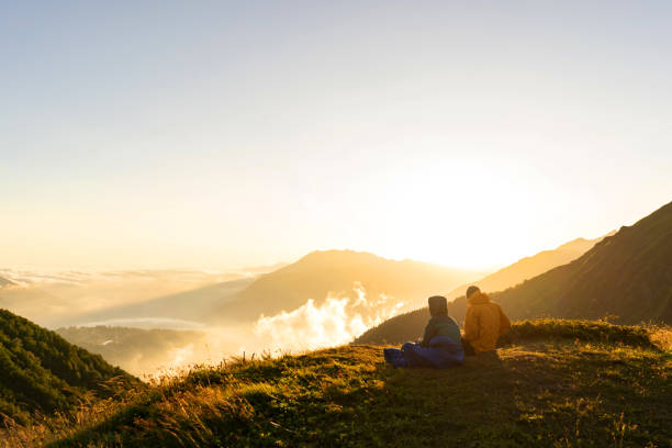 istock couple on the mountain watching the sunset 1168751173