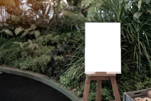 istock Wood mockup frame posters pattern template background for letter ready to use display your product,Placed in front of a coffee shop full of fern trees.background insert for space for texting. 1168751258