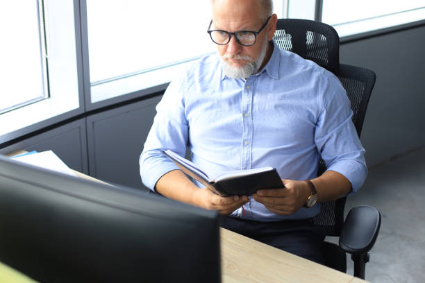istock Confident pensive mature business man in modern office. 1168752001
