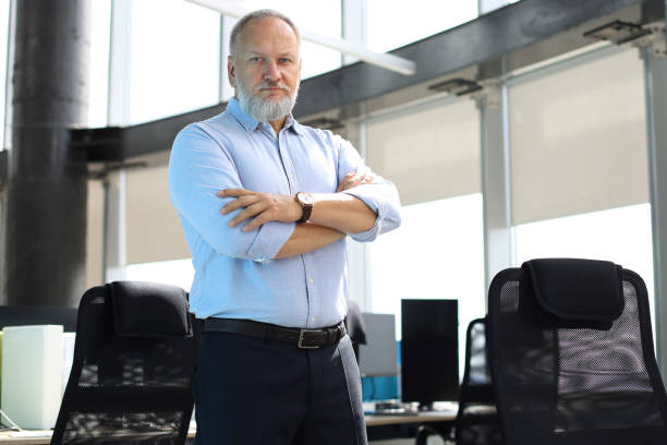 istock Confident pensive mature business man in modern office. 1168752075