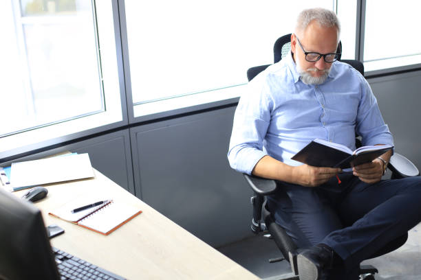 istock Confident pensive mature business man in modern office. 1168752140