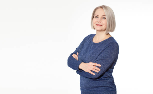 istock Attractive middle aged woman with folded arms on white background 1168752563