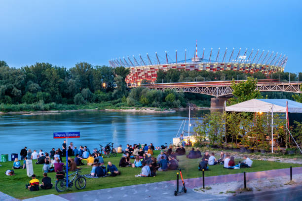 people by the river e stadio nazionale di varsavia - fiume vistola foto e immagini stock