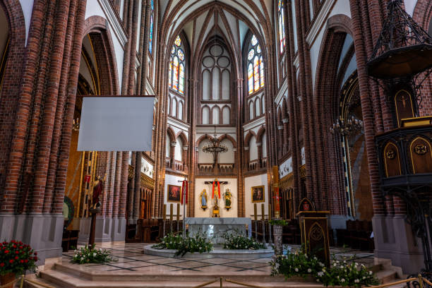 Warsaw, Poland - May 12, 2019: High altar in Cathedral of St. Michael the Archangel and St. Florian the Martyr interior, Gothic Revival style city landmark.