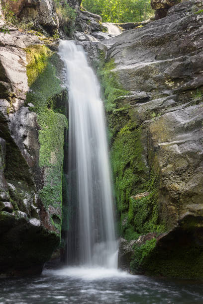 istock Wonderful mountain waterfall cascading down the moss covered cliff 1168754462