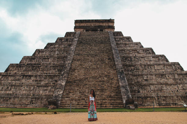 istock Girl standing at Kukulkan pyramid in Chichen Itza 1168754992