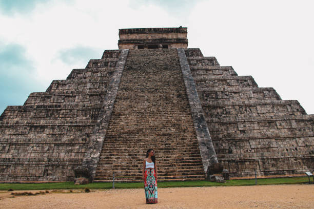 istock Girl standing at Kukulkan pyramid in Chichen Itza 1168756137