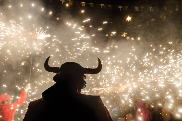 An scene of the popular fiesta of correfocs, in Barcelona. Devil with horns in front.