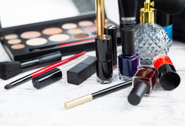 istock Professional makeup set: eyeshadow palette, lipstick, nail polish, blush, make-up brushes and perfume, many cosmetics closeup. 1168757270