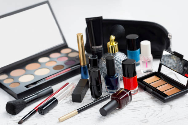 istock Professional makeup set: eyeshadow palette, lipstick, nail polish, blush, make-up brushes and perfume, many cosmetics closeup. 1168757282