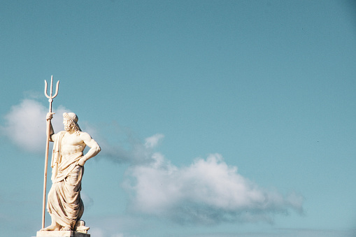 god of sea poseidon statue clear blue sky background