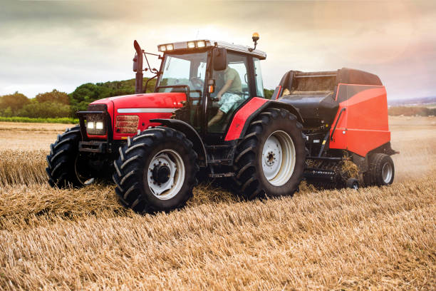 istock tractor and its trailer to press the straw 1168759001