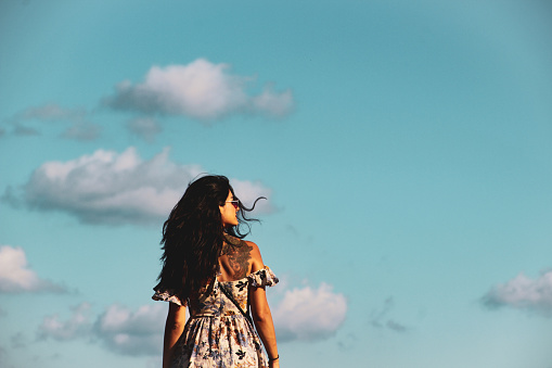 cinematic based woman only photo, woman looking to the sky in Havana port in Cuba