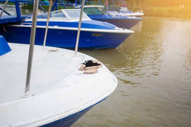 Damaged speedboat is parking on the river. Damaged speedboat is parking on the river. White and blue speedboat damaged. Thailand. motorboat maintenance stock pictures, royalty-free photos & images