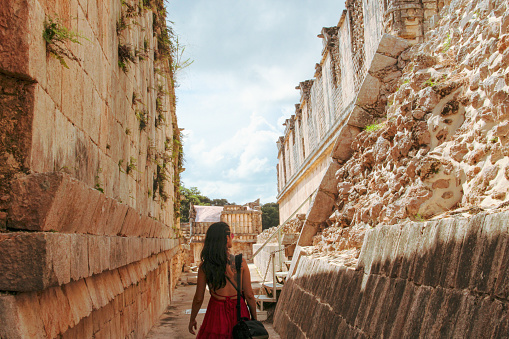 Girl relaxing on the mayan pyramid in ancient city of Uxmal in Yucatan