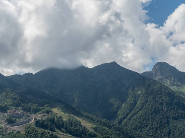 istock Beautiful green mountains with clouds Rosa Khutor Sochi in summer 1168760525