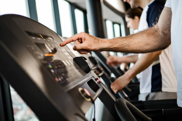 istock Senior man on a treadmill pushing buttons 1168764578