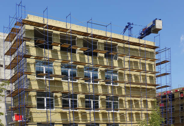 istock Solid wall insulation with rock wool. Energy efficiency house wall renovation for energy saving. Exterior house wall heat insulation with mineral wool. External wall insulation. 1168766120