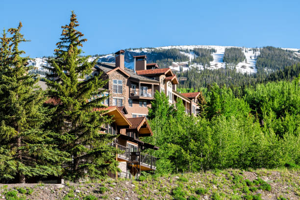 Aspen Snowmass village town houses on hill in Colorado dummer with snow mountain Aspen Snowmass village town houses on hill in Colorado dummer with snow mountain aspen colorado photos stock pictures, royalty-free photos & images