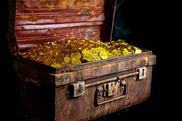 istock Stacking Gold Coin in treasure chest  on black background 1168770007