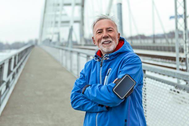 istock Active senior man posing on a bridge on a winter day 1168770122