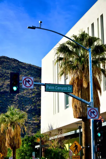A single surveillance camera used for traffic control is seen mounted on a lamppost, Palm Canyon Drive,  in Palm Springs, California, Coachella Valley, Southern California, USA.