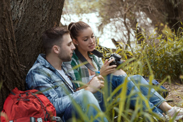 istock Young couple are resting in nature looking through photos 1168772218