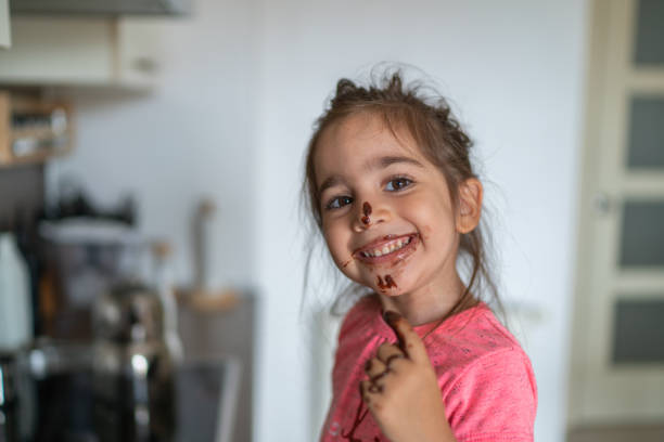 istock Child eating chocolate with her finger 1168772957
