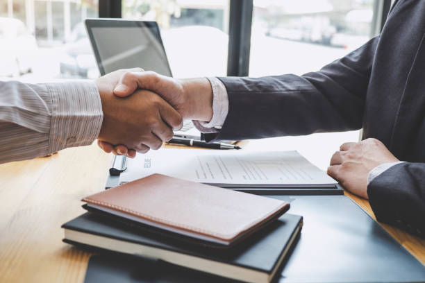 istock Greeting new colleagues, Handshake while job interviewing, male candidate shaking hands with Interviewer or employer after a job interview, employment and recruitment concept 1168773303