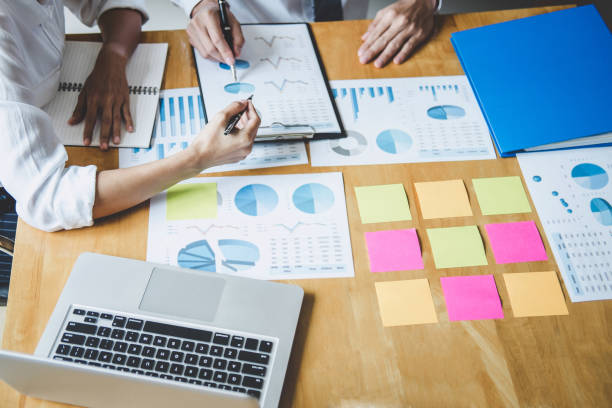 istock Co working conference, Business team colleagues discussing working analysis with financial data and marketing growth report graph in team, Meeting Talking Brainstorming Communication Concept 1168773486