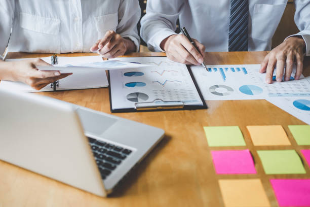 istock Co working conference, Executive team discussing the charts and graphs working in business strategy and financial plan to investment profit 1168773506