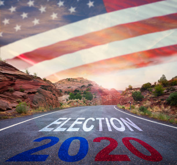 istock Election 2020 road sign with American flag 1168774199