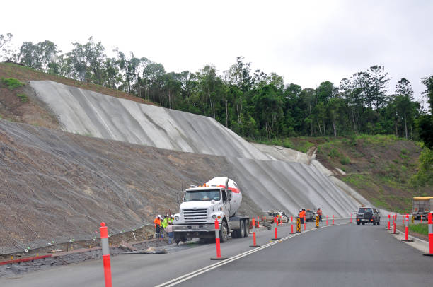 upgraded at last BLACKBUTT RANGE, QUEENSLAND, AUSTRALIA, MARCH 5: Work continues to upgrade a dangerous stretch of road on 5-3-2013 at the Blackbutt Range in Queensland. The road was extensively damaged during recent floods. queensland floods stock pictures, royalty-free photos & images
